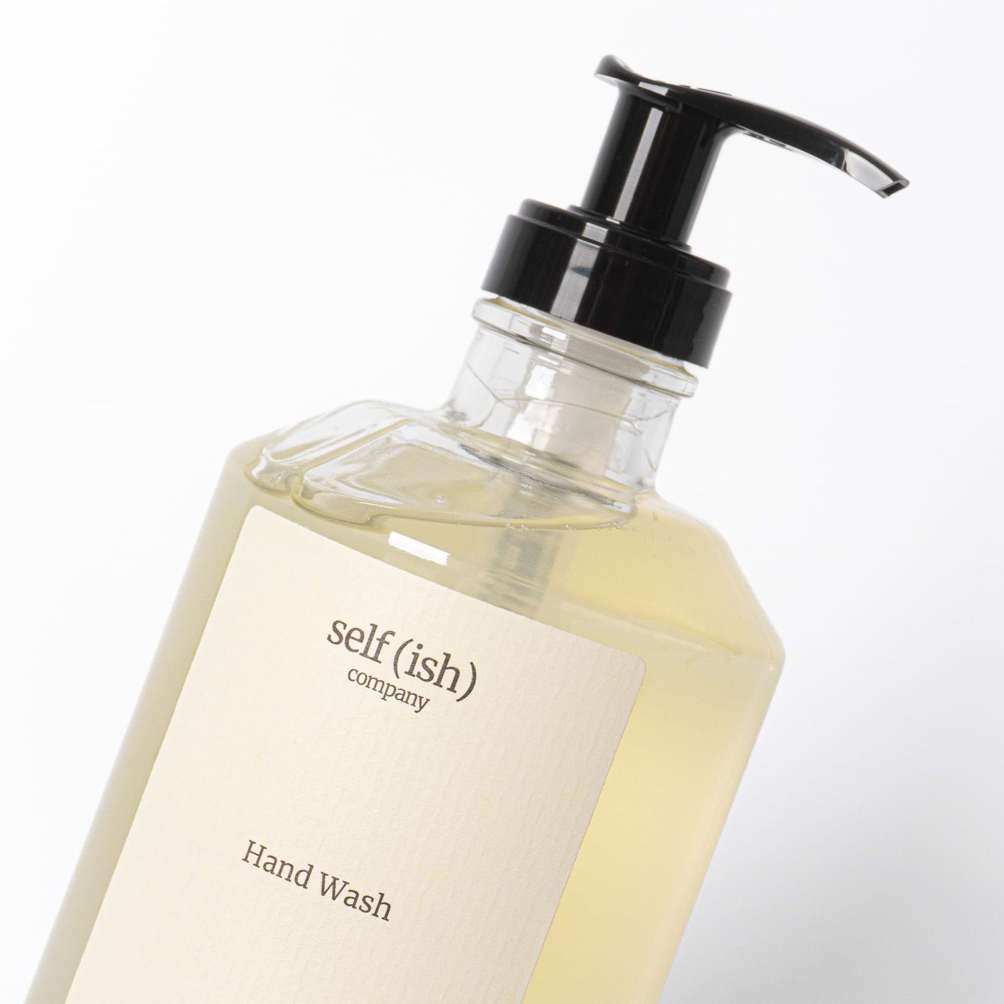 hand soap close-up with a heavy-duty glass bottle and black plastic pump, scented with lavender cypress and lemongrass essential oils and enhanced with natural hemp oil
