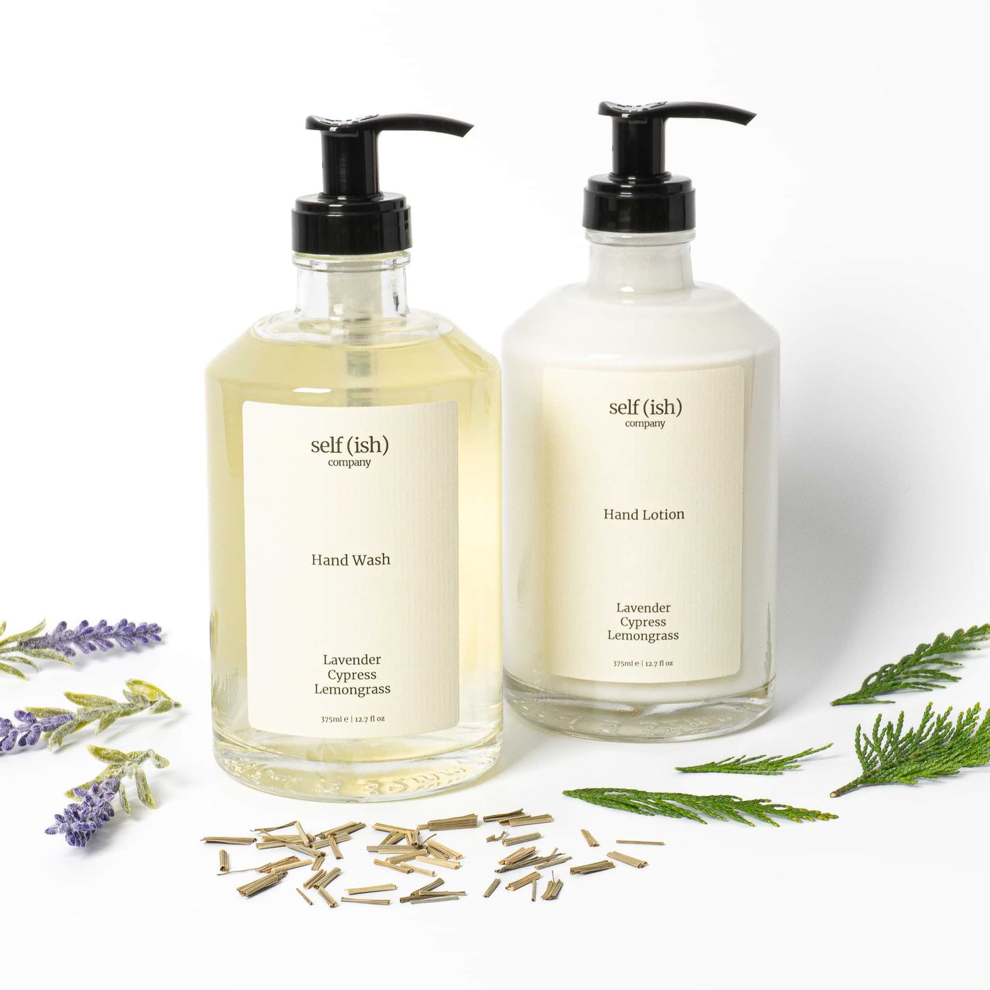 hand soap and hand lotion set in clear glass bottles with black plastic pumps and minimalistic labels