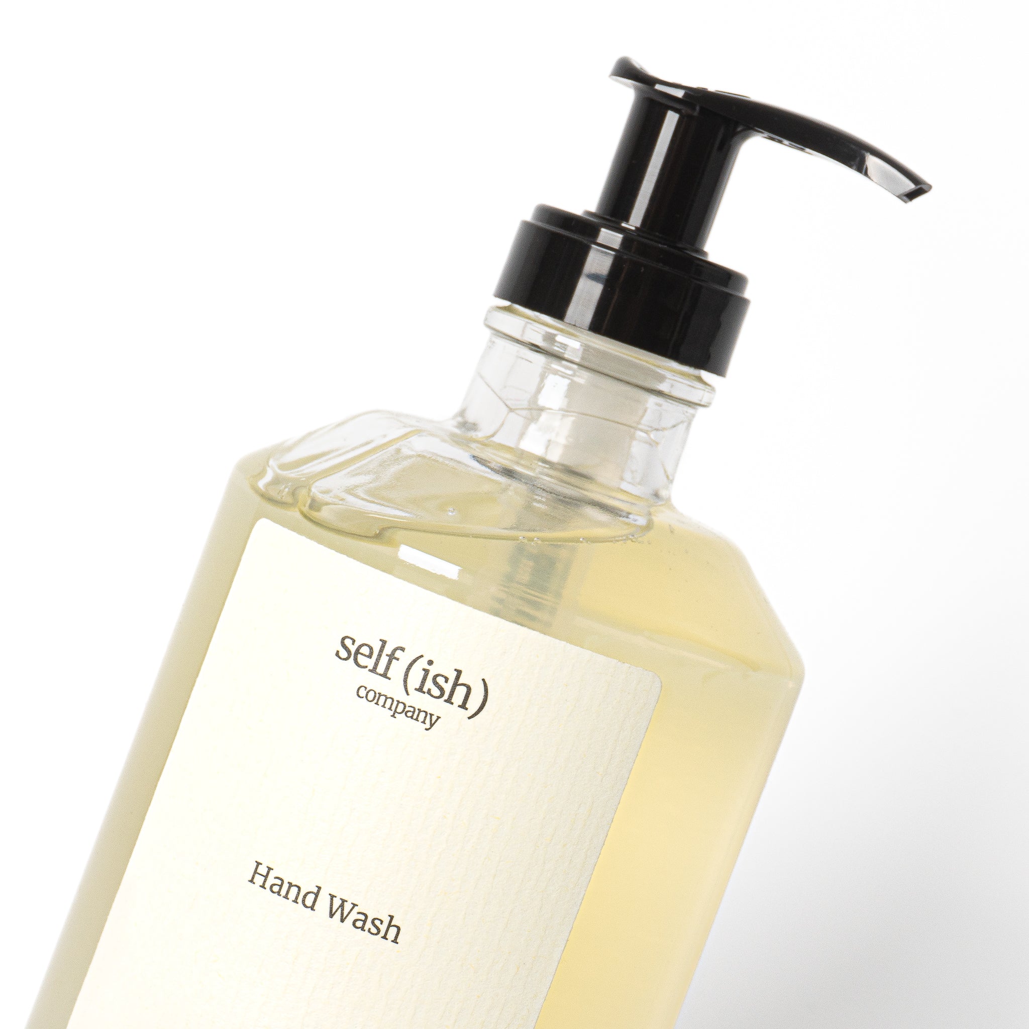 hand soap close-up with a heavy-duty glass bottle and black plastic pump, scented with lavender cypress and lemongrass essential oils and enhanced with natural hemp oil