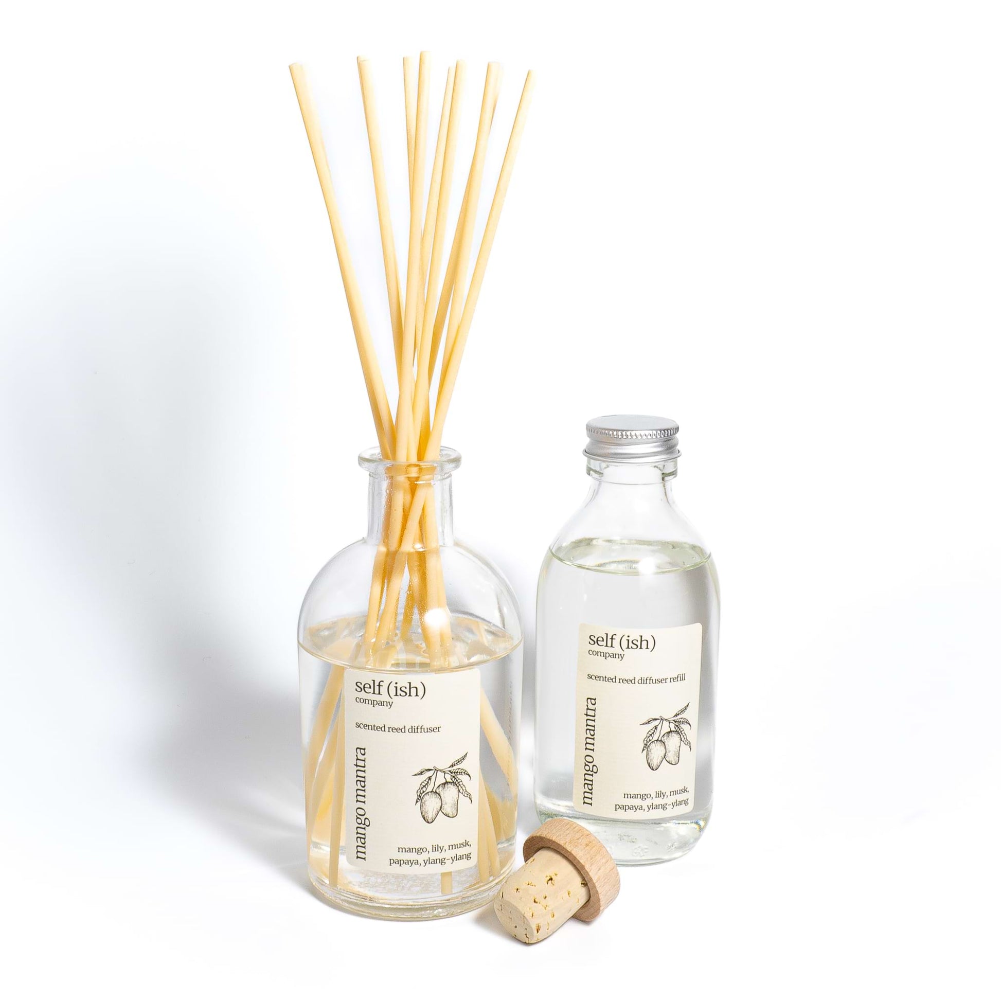Mango diffuser refill bottle next to mango reed diffuser
