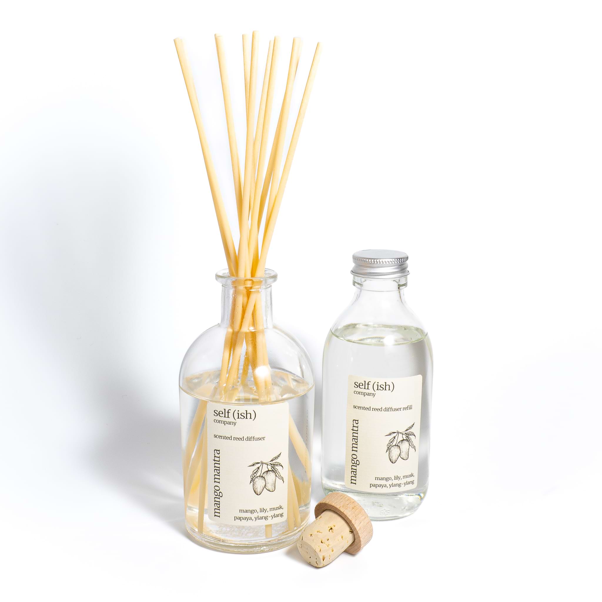 Mango diffuser refill bottle next to mango reed diffuser