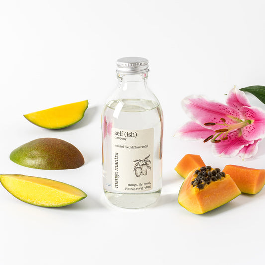 200ml mango reed diffuser refill surrounded by fresh fruits