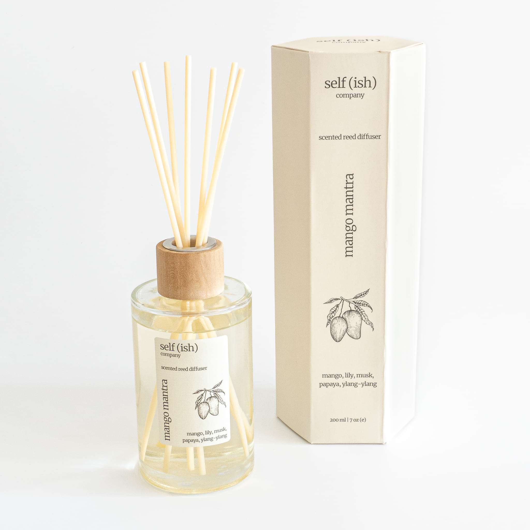 mango scented reed diffuser in glass bottle with wooden cap and hexagonal gift packaging