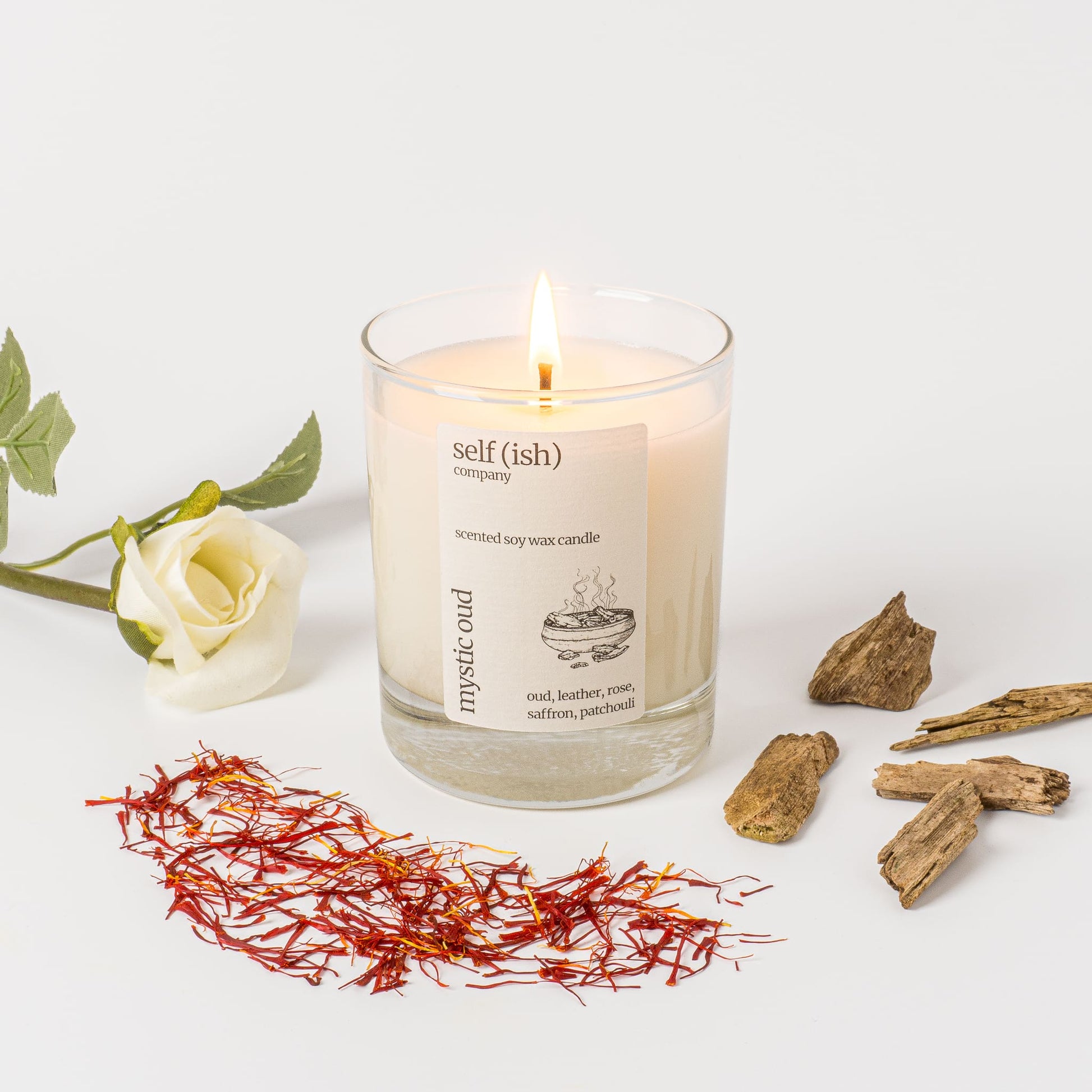 oud scented soy wax candle with a burning single wick and pretty label, eco-friendly candle for sale suitable for vegans, best candle to buy online in the UK, handcrafted candle