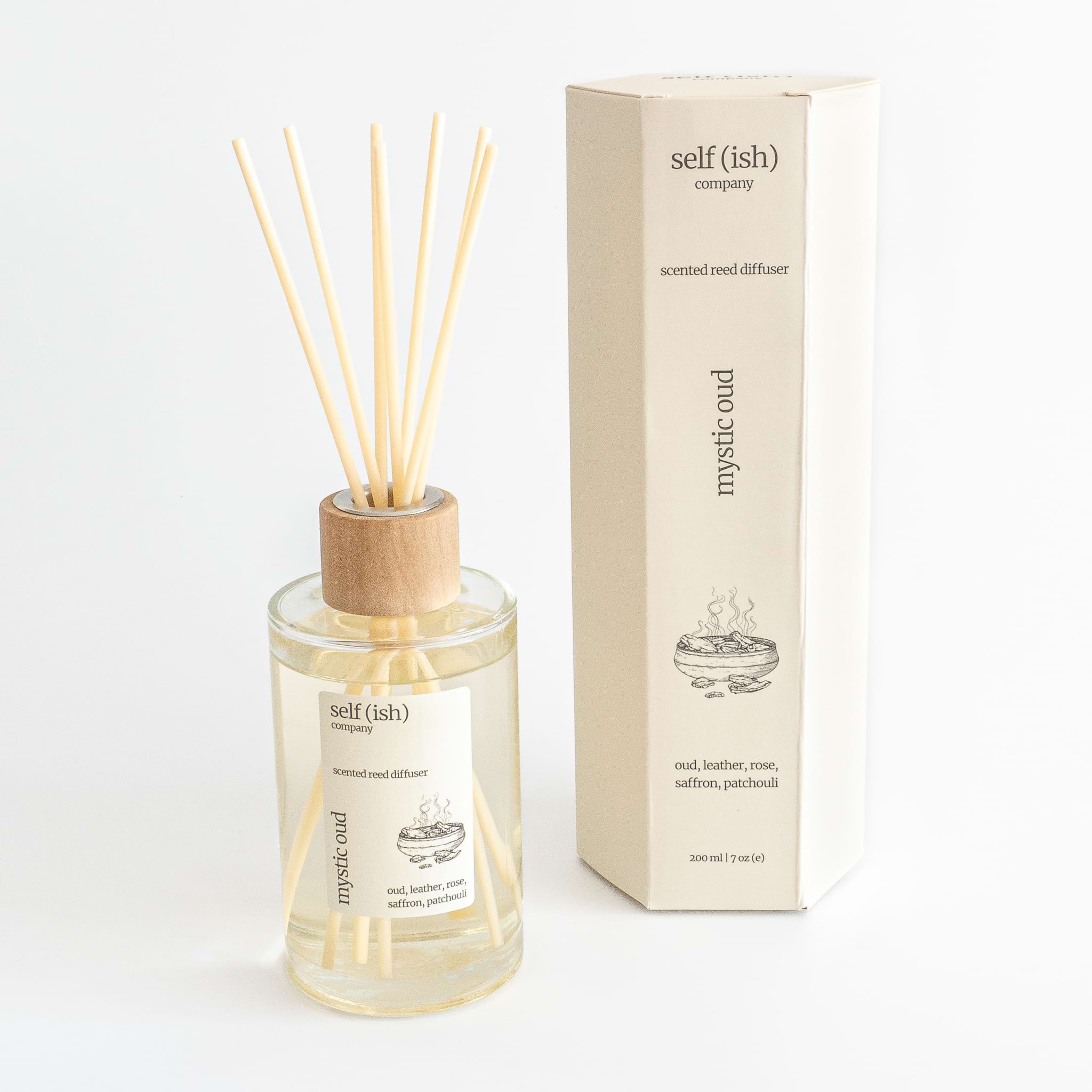 oud scented reed diffuser in glass bottle with wooden cap and hexagonal gift packaging