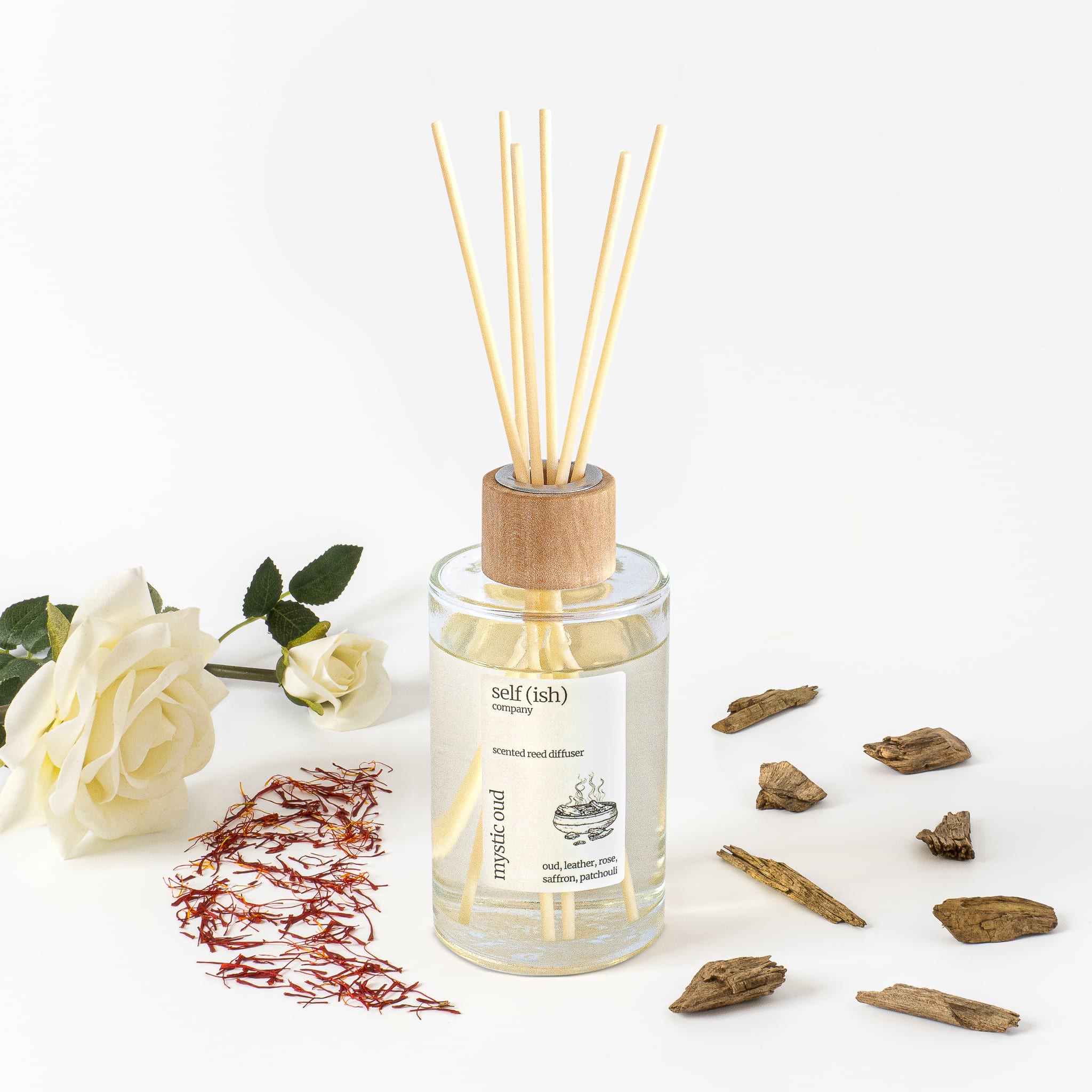 oud reed diffuser with saffron and white rose with white background