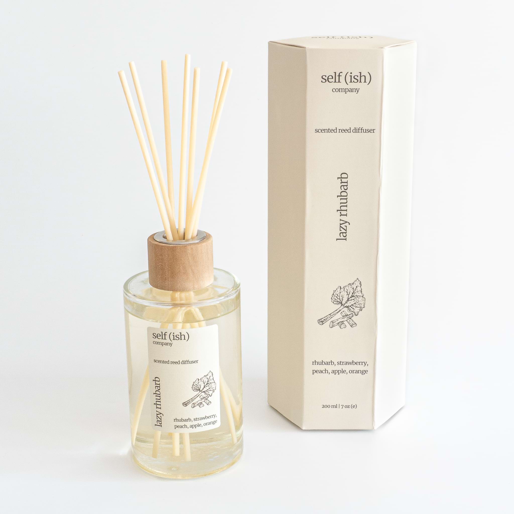 rhubarb scented reed diffuser in glass bottle with wooden cap and hexagonal gift packaging