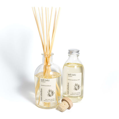 rum diffuser refill bottle next to rum reed diffuser