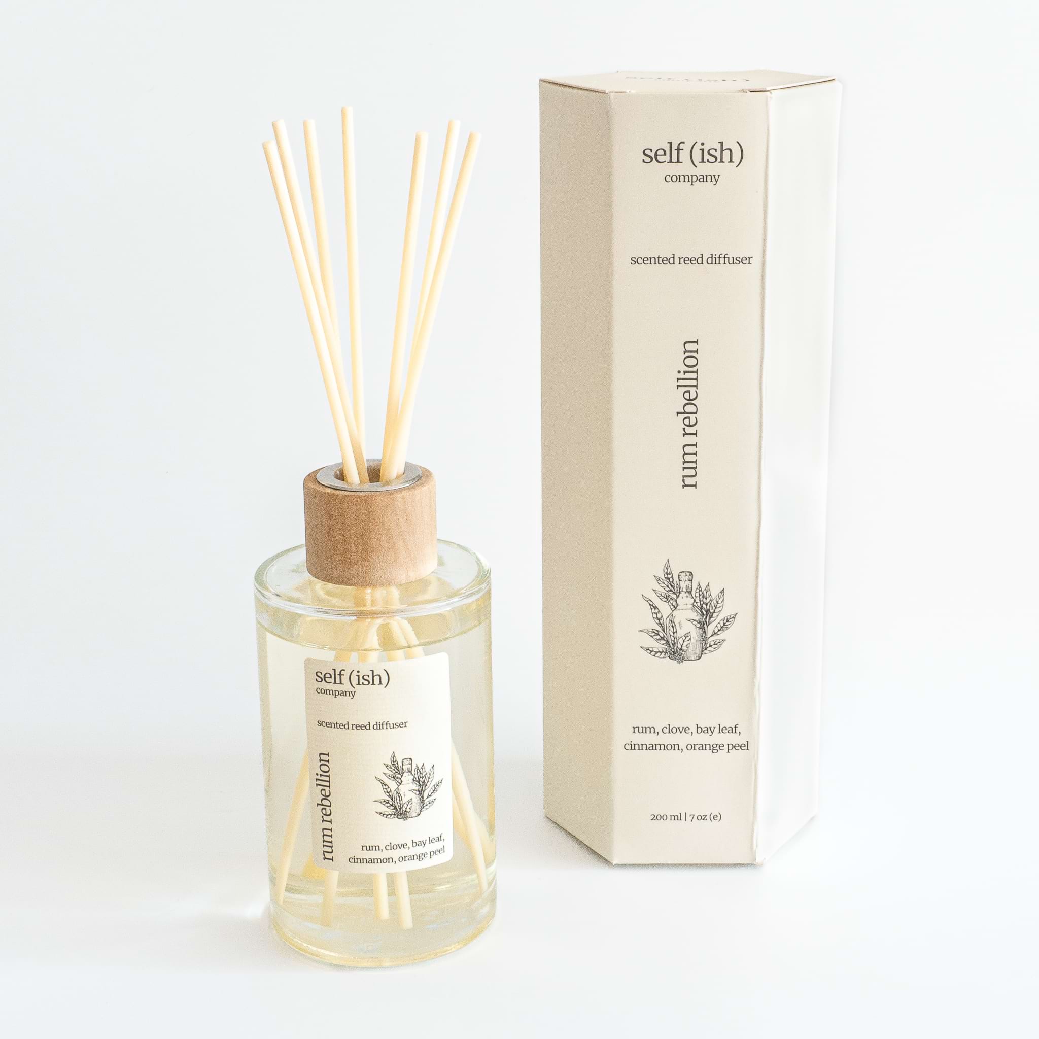 rum scented reed diffuser in glass bottle with wooden cap and hexagonal gift packaging