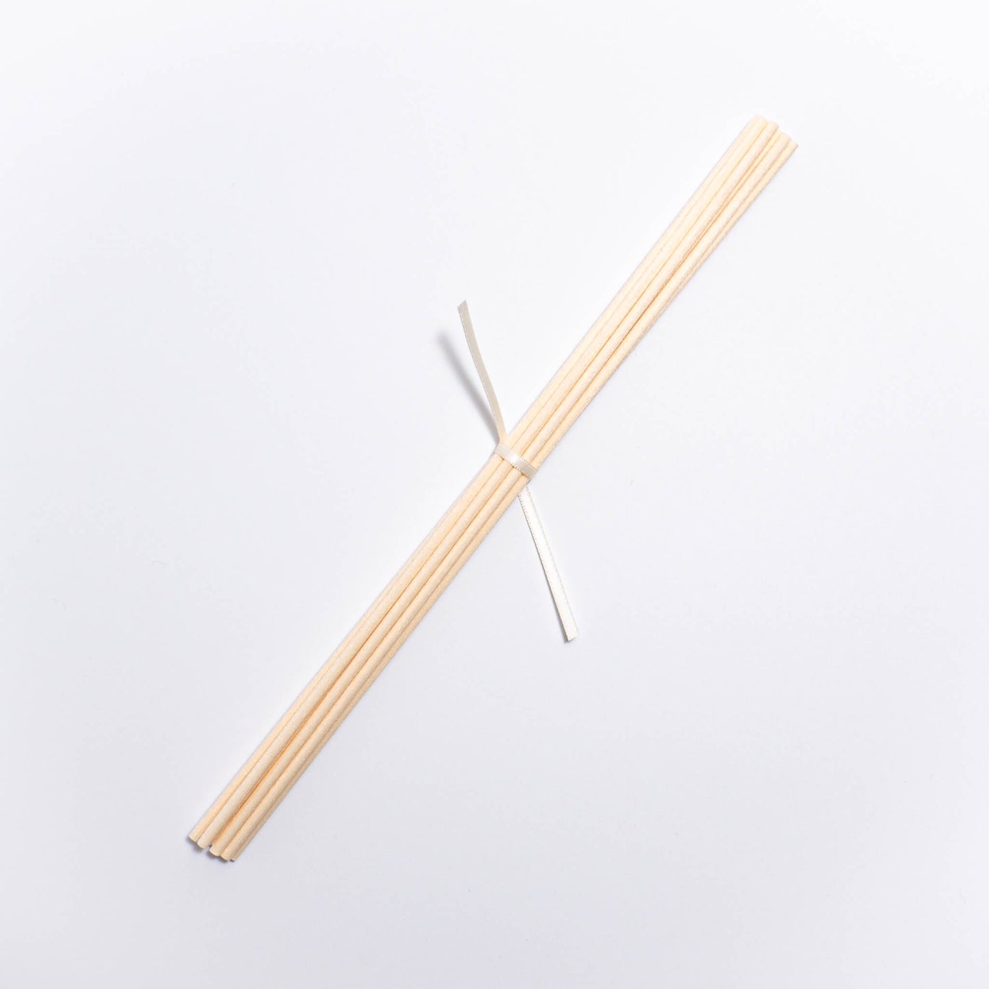 set of 10 replacement reed diffuser sticks available for purchase made from natural fibres, natural colour and wrapped with ivory ribbon